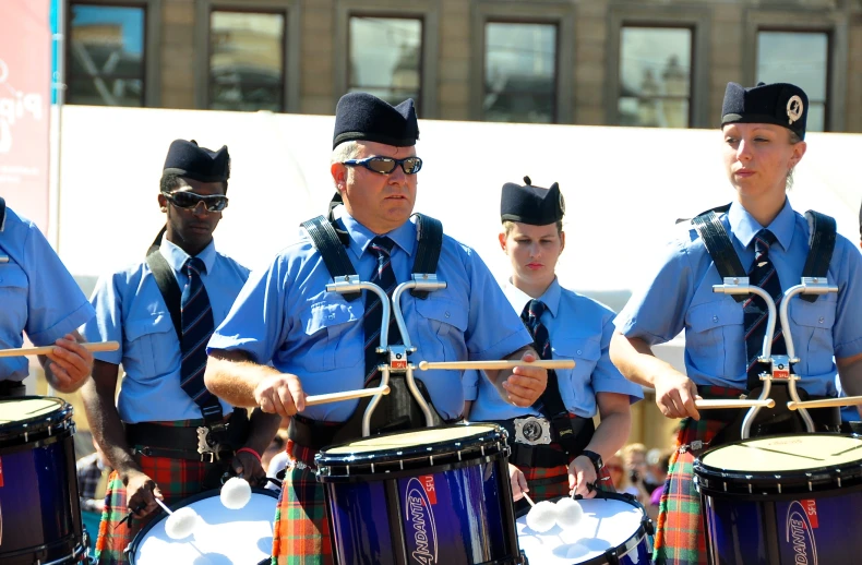 a group of men in police uniforms playing drums