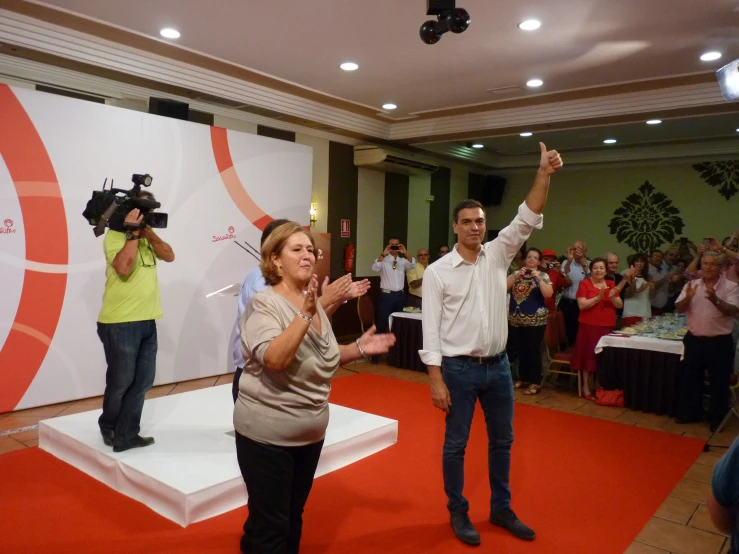 people doing different gestures with their arms up on a white pedestal