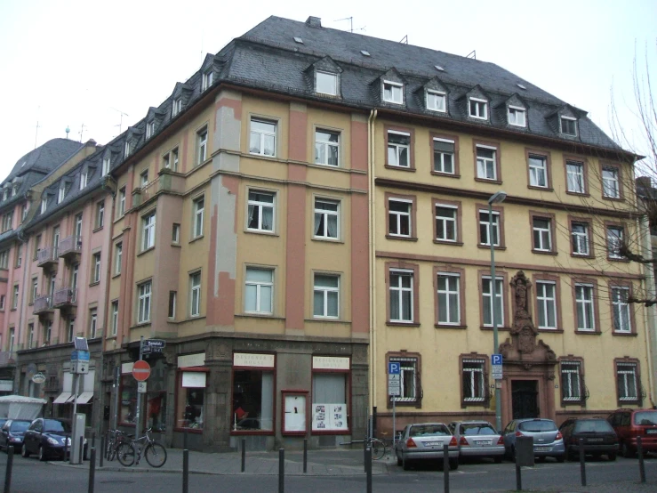 an old building on the corner of an intersection