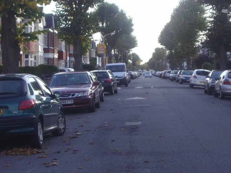 cars line the city street in this residential area