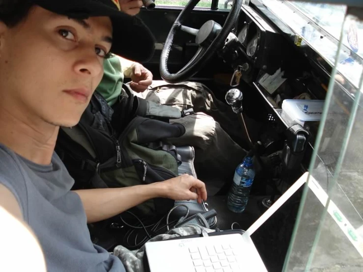 a person is using a laptop on a vehicle