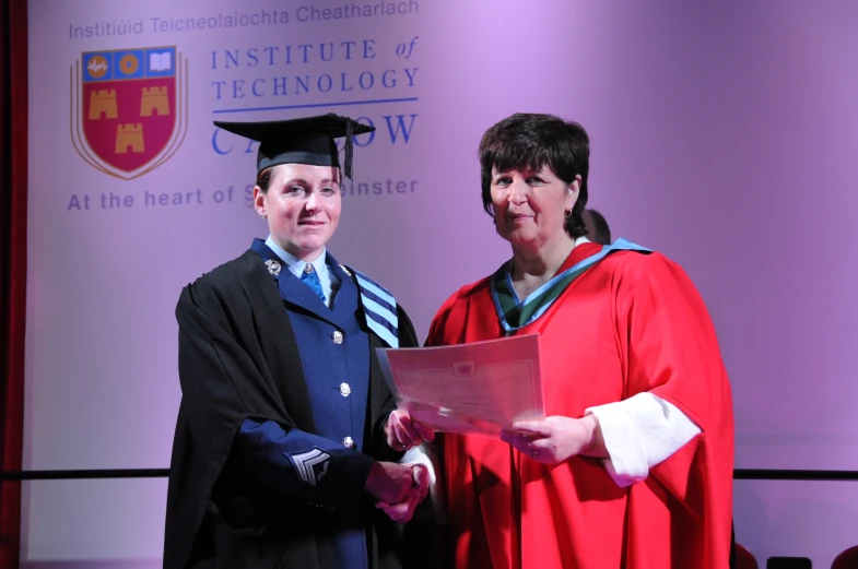 two graduates receiving the university's honorary certificate