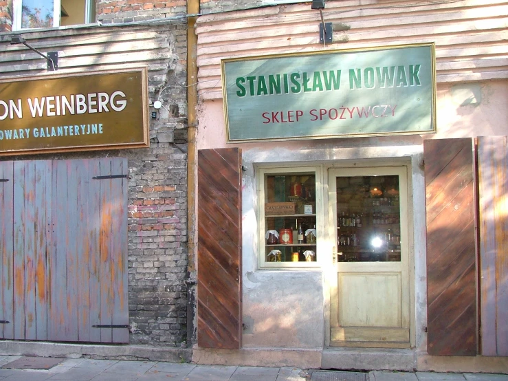 a storefront with large wooden doors on the front