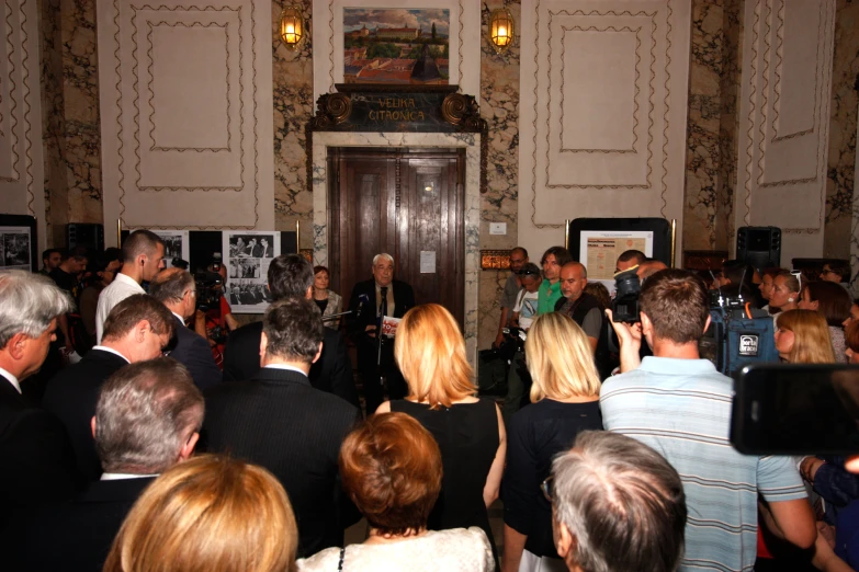 a man is standing in front of a group of people