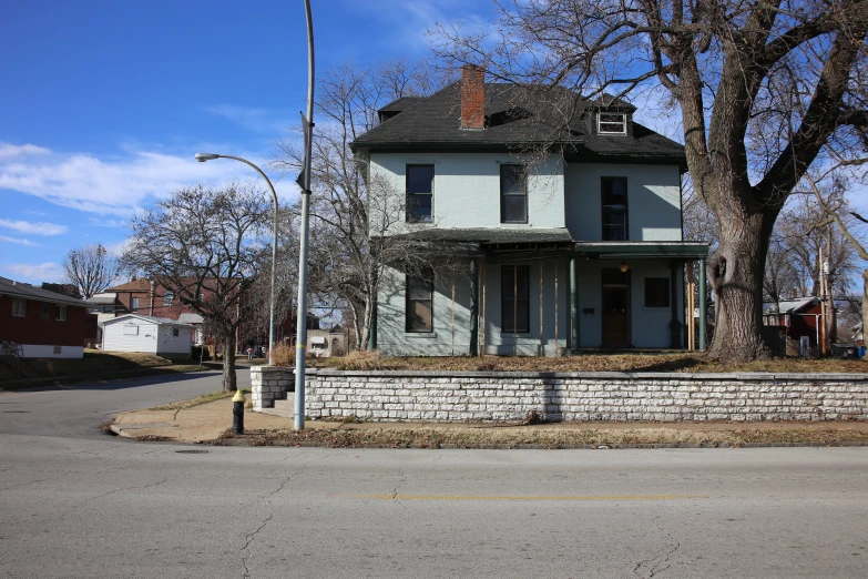 an old abandoned house is shown against the blue sky