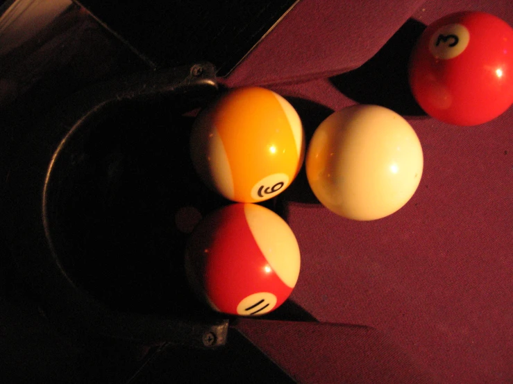 three billiard balls sitting next to each other