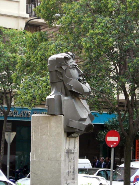 this statue is designed like a lion's head on a sidewalk