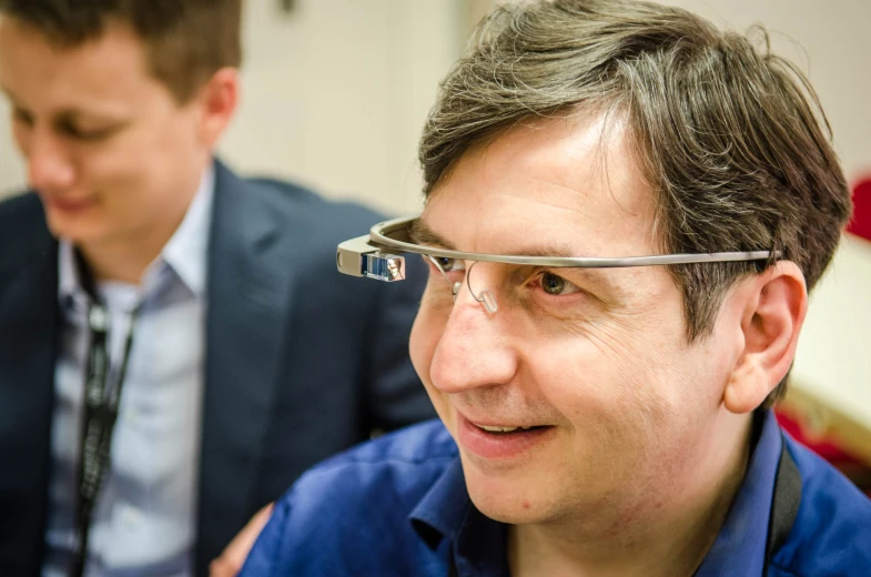 a man wearing google glasses looking around his neck