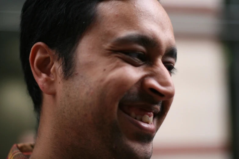 man smiling and holding a phone to his ear