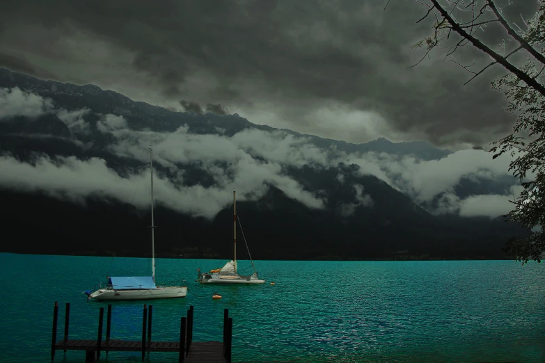 a body of water filled with a couple of boats floating