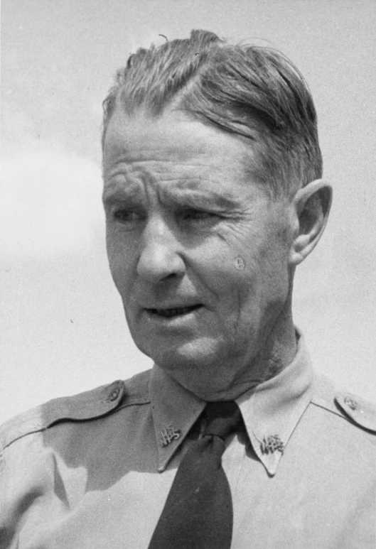 this is a black and white picture of a man in uniform