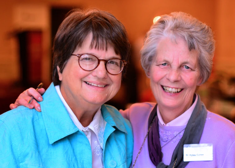 an old lady and a young woman pose for a picture