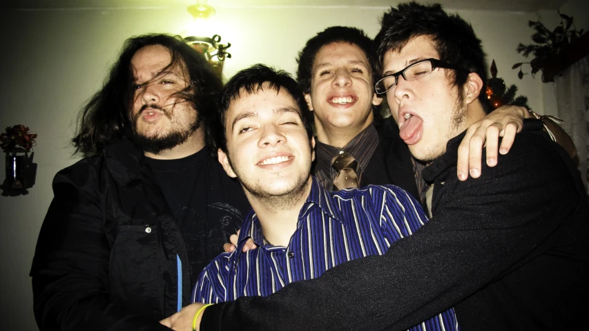 three guys are posing for the camera with their tongues in their mouth