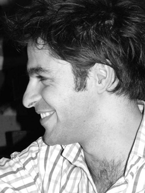 a black and white image of a person smiling