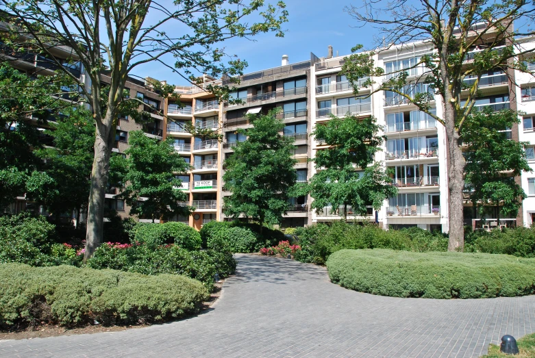 two buildings in a courtyard with a pathway to the ground