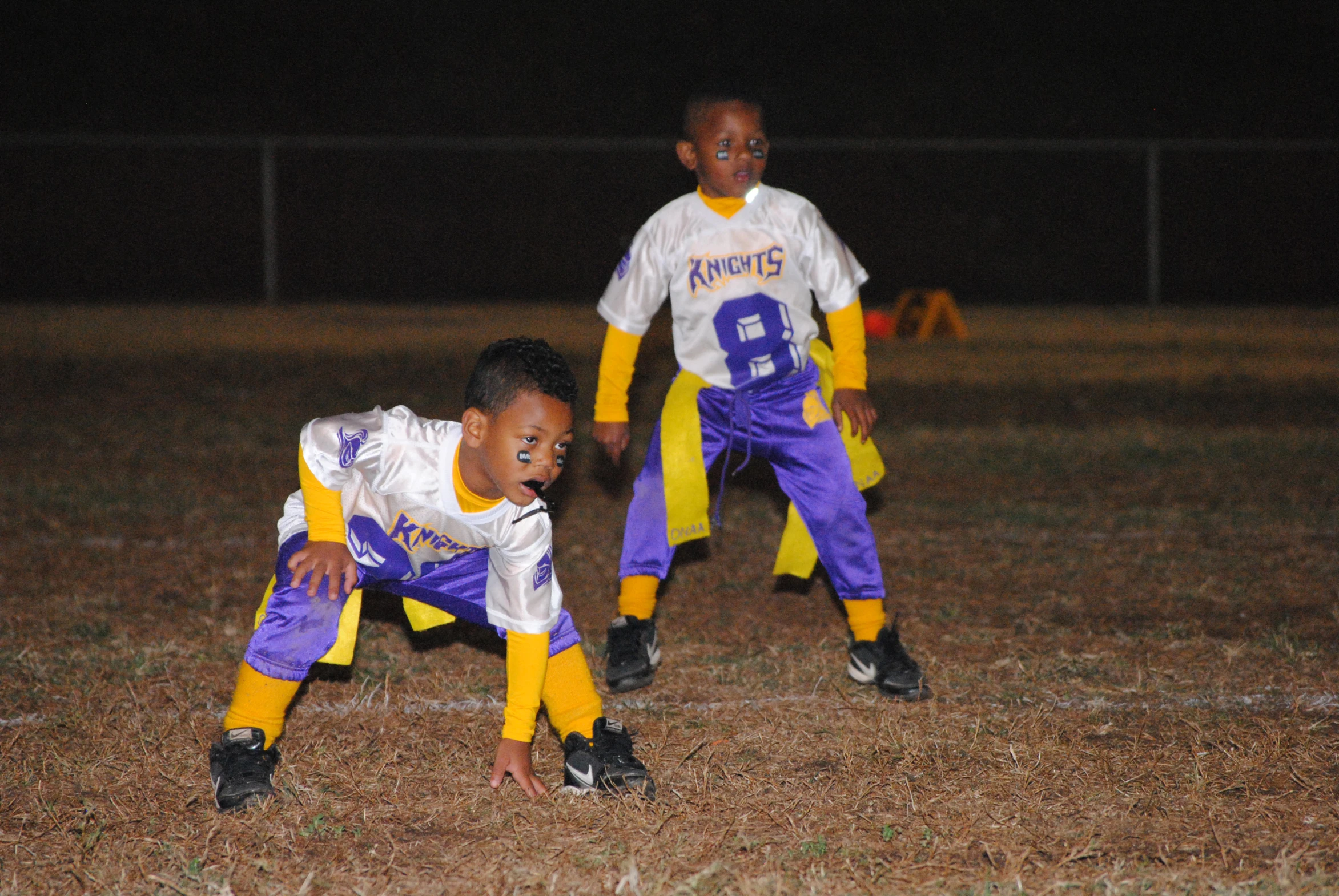 a couple of boys playing in a field