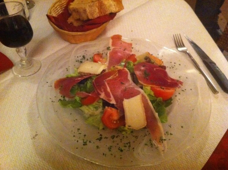 a plate full of food next to a wine glass