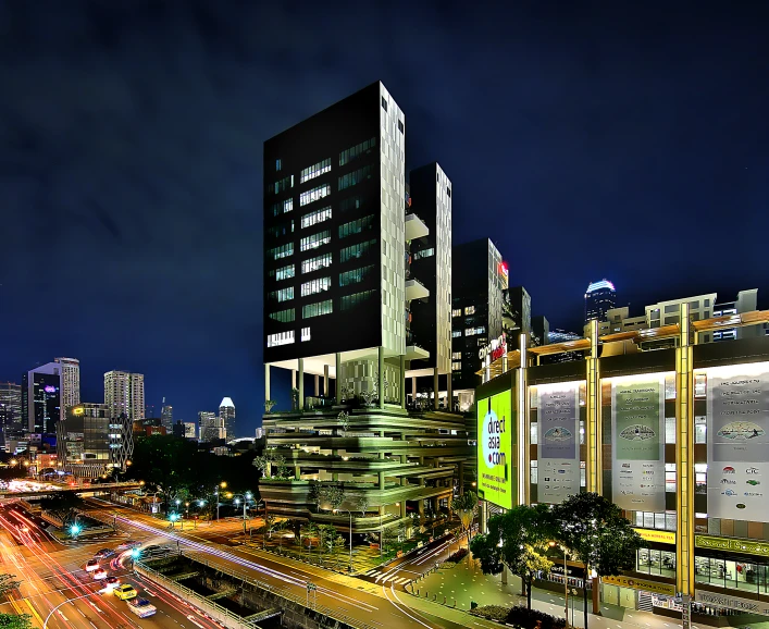 city scene at night showing large skyscrs lit up