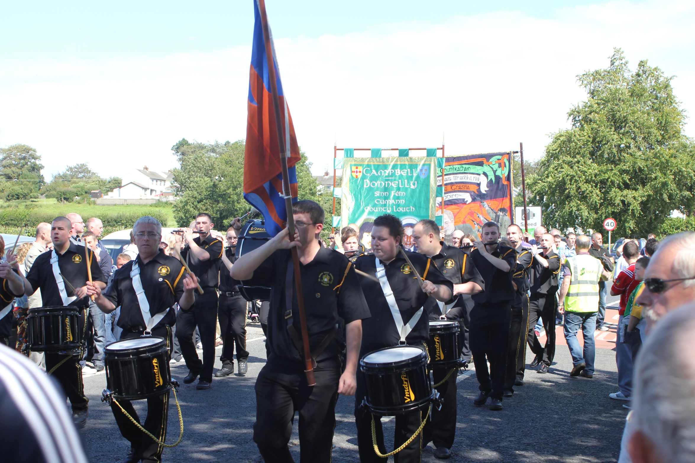 a marching band is performing in front of a large crowd