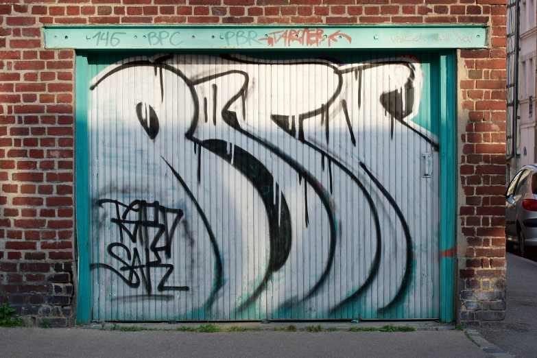a close up of a garage door with graffiti