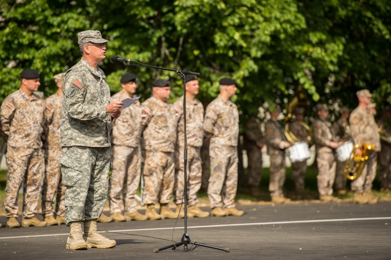 a group of military men standing around in front of microphones