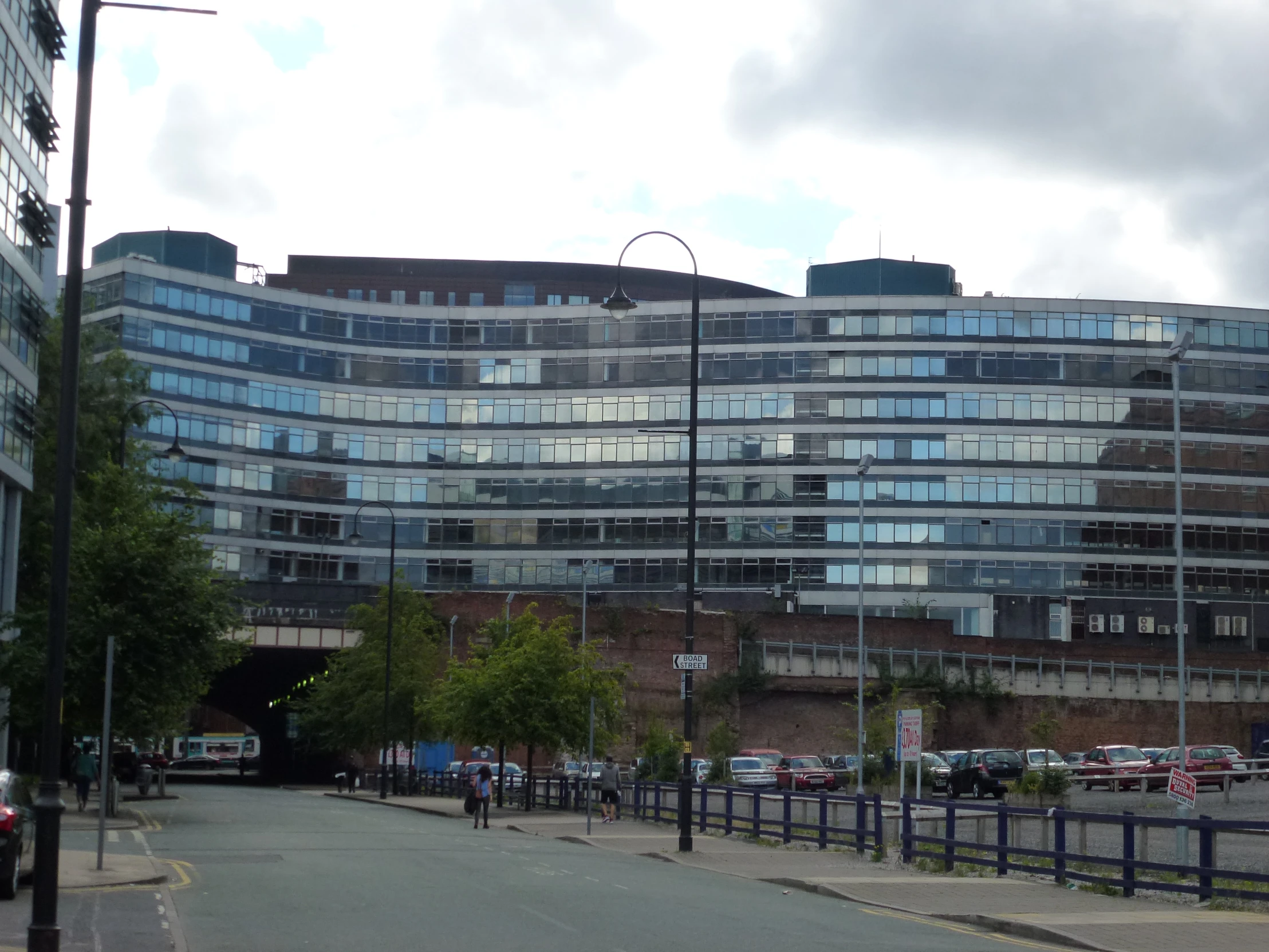 a large building sitting next to a street filled with traffic