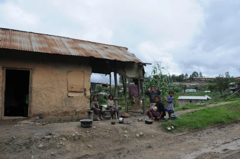 three people that are standing near a house