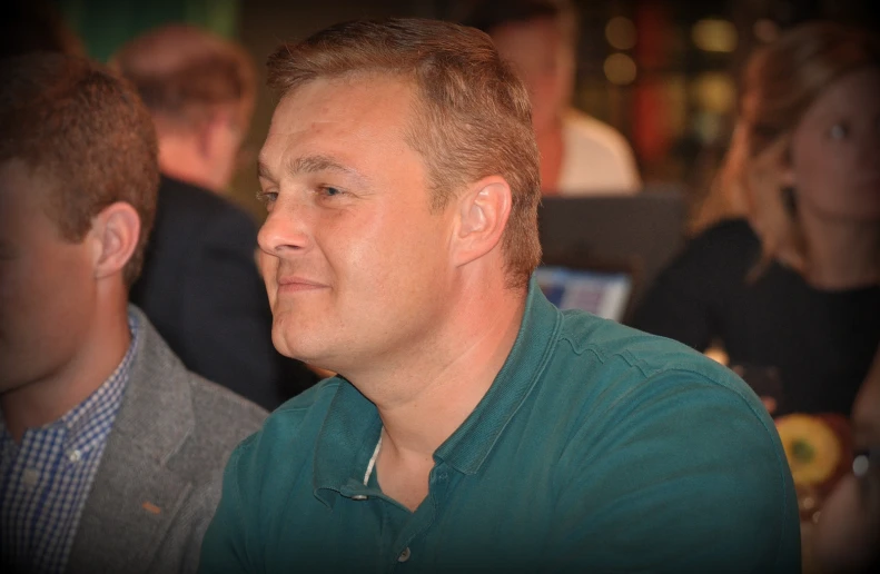 a man is sitting in a restaurant looking towards the side