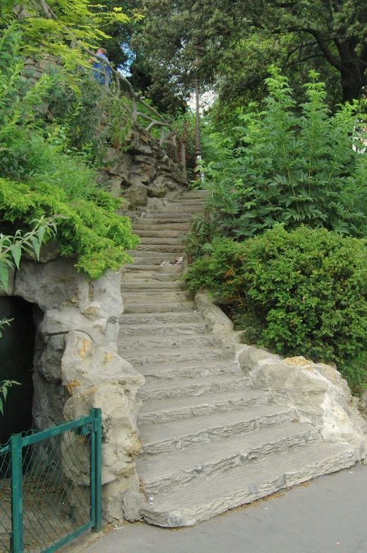 the steps lead up to the tunnel at the bottom of this hill