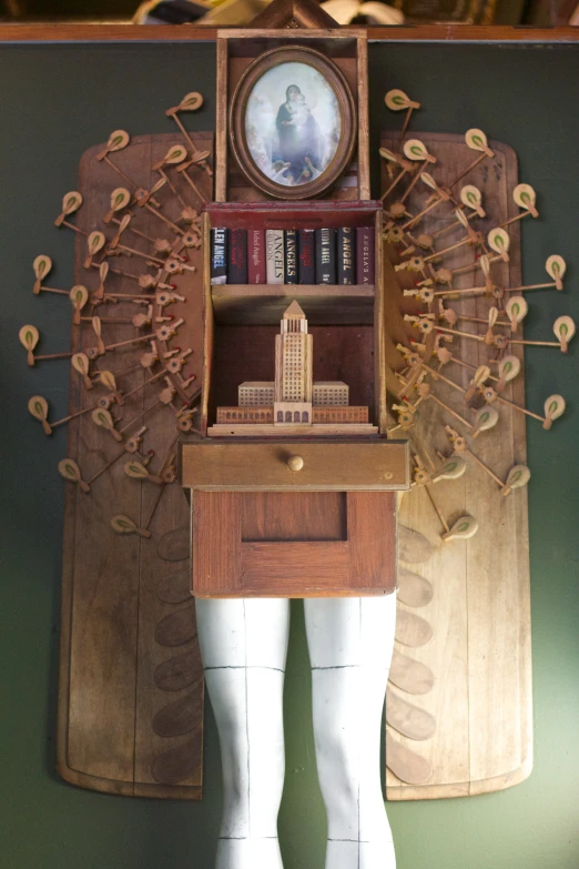 a doll standing in front of a clock and bookshelf