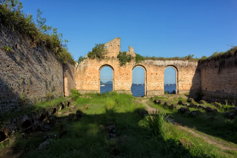 an old brick building sitting along side a body of water