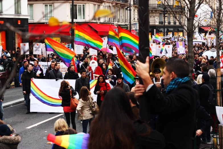 a large group of people marching through a city street