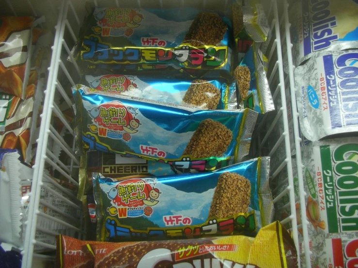 several bags and snacks in a refrigerator