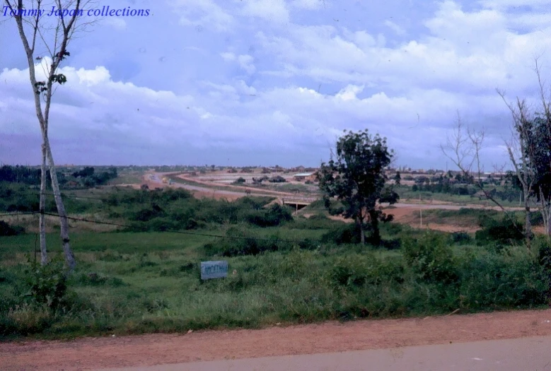 view of a dirt road and grassy field