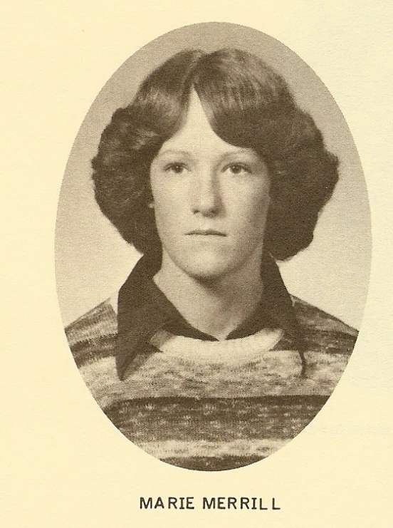 a lady with big hair and a black and white po