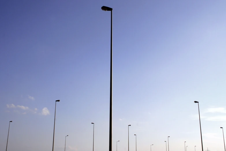 a large parking lot that is filled with lots of light poles