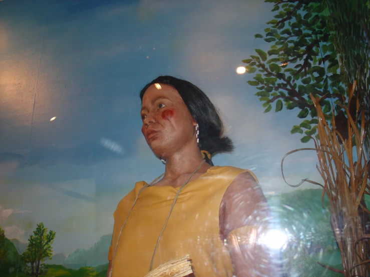 a woman is looking up at the sky with her nose painted yellow