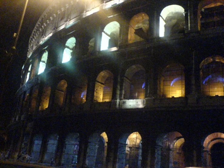 an empty building at night lit up by street lamps