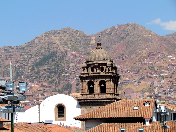 a church steeple with the town behind it