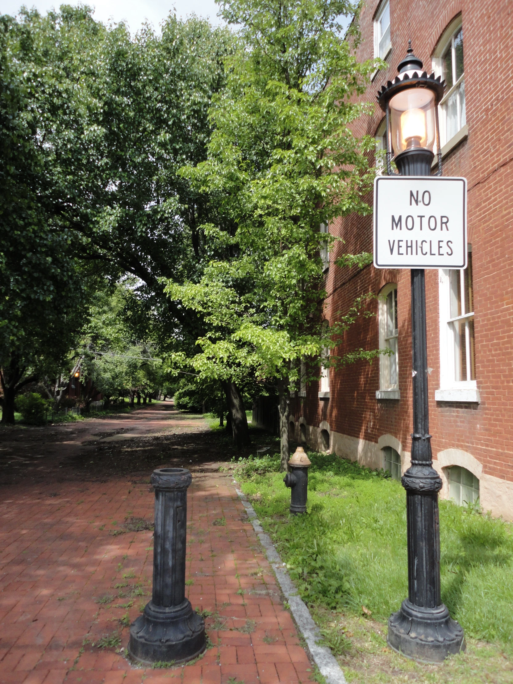 a white street sign hanging from the side of a metal pole