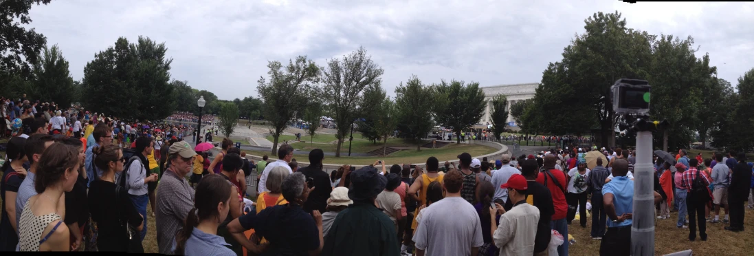 a large crowd of people standing on the grass