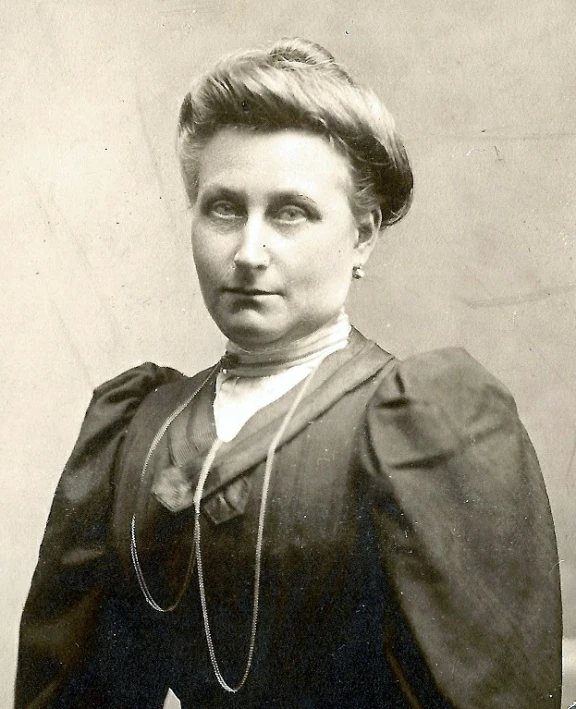 a black and white po of a woman wearing a long coat