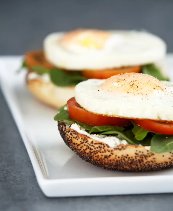 a sandwich topped with two eggs on top of bread