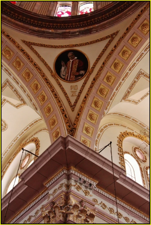 inside the ornate ceiling of a cathedral with a stained glass window