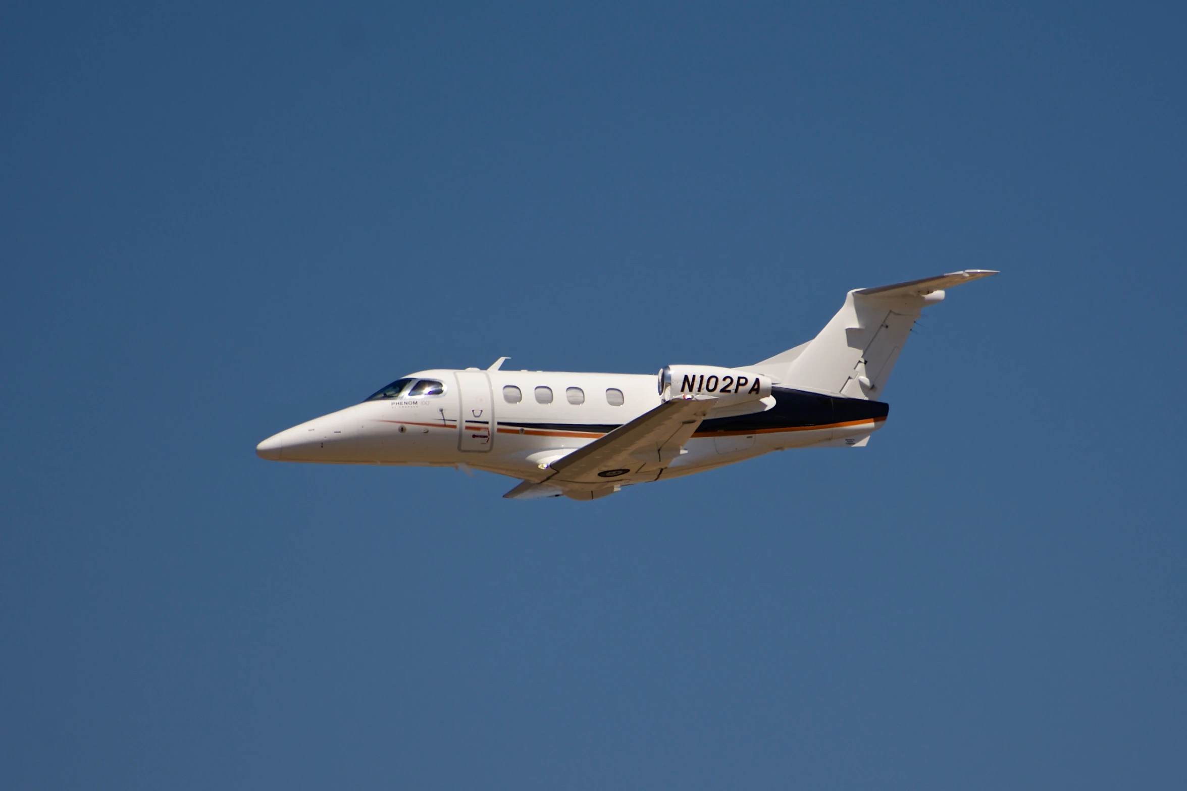 a small plane is flying through the blue sky