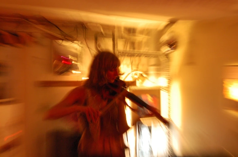 a blurry image of a woman playing a violin