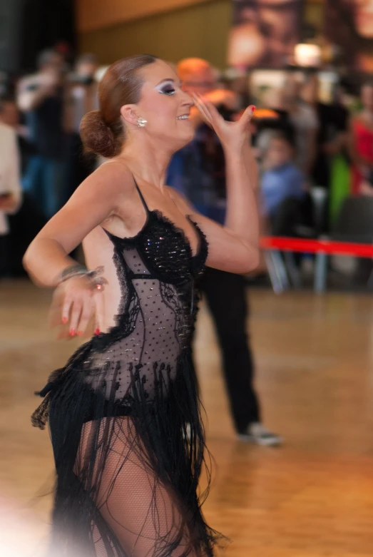 a woman in black gown holding a cigarette