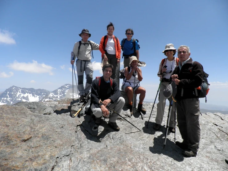 several hikers are standing on top of a mountain