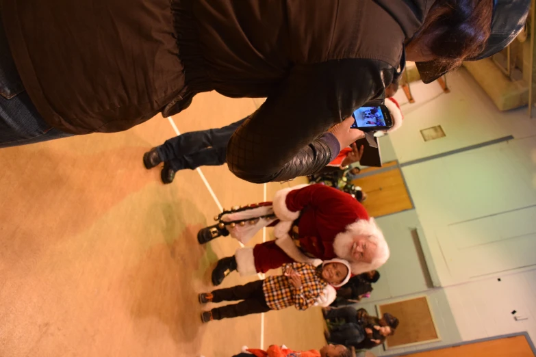 a father christmase with his children and santa