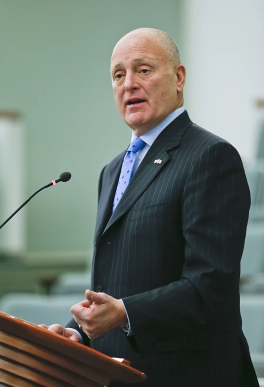 a man speaking in front of a microphone